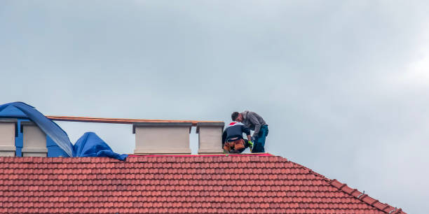 nitra, slovakia 05.15.2023: handymen repair chimneys on the roof of a house.